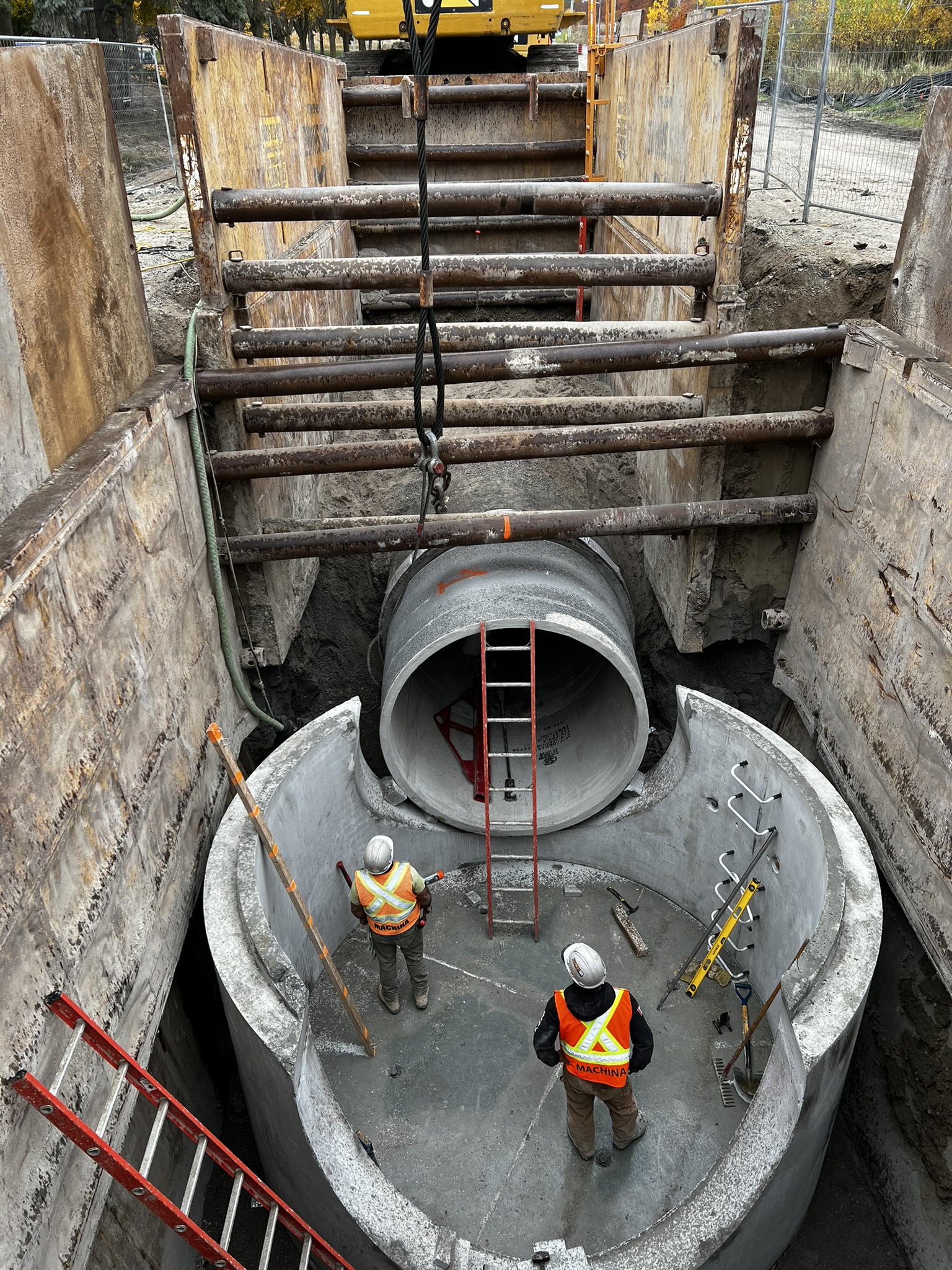 Crew installing large diameter sewer main